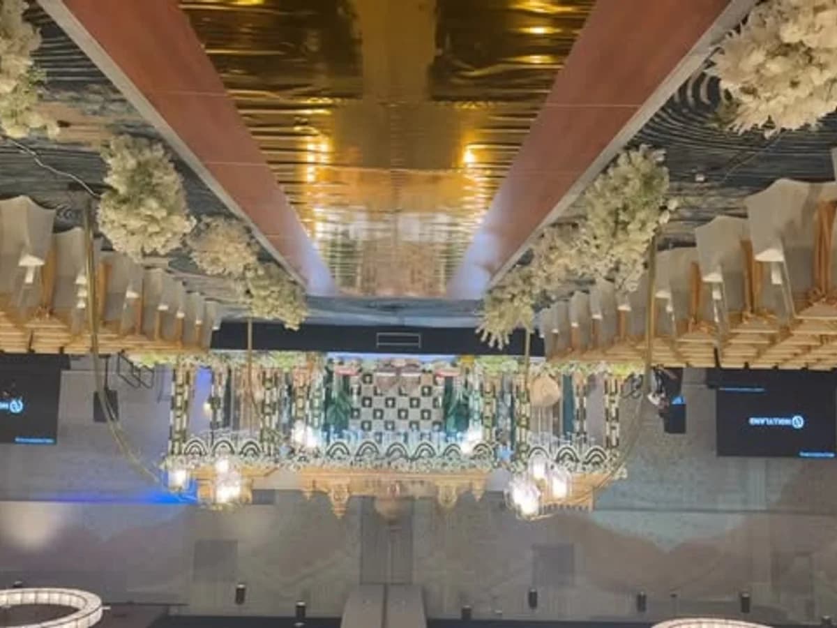 Formal ballroom aisle with white floral arrangements